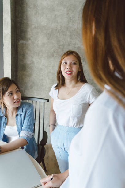 istock Female coworkers discussing a project in a new office space 694616912