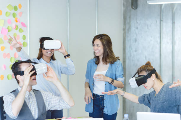 istock Colleagues working together on a virtual reality project in start-up office environment 694616962