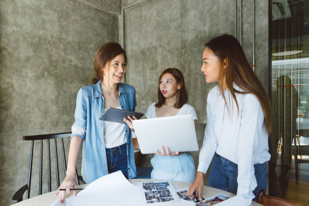istock Female coworkers discussing a project in a new office space 694619440