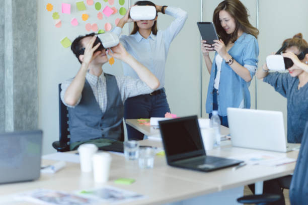 istock Colleagues working together on a virtual reality project in start-up office environment 694622712