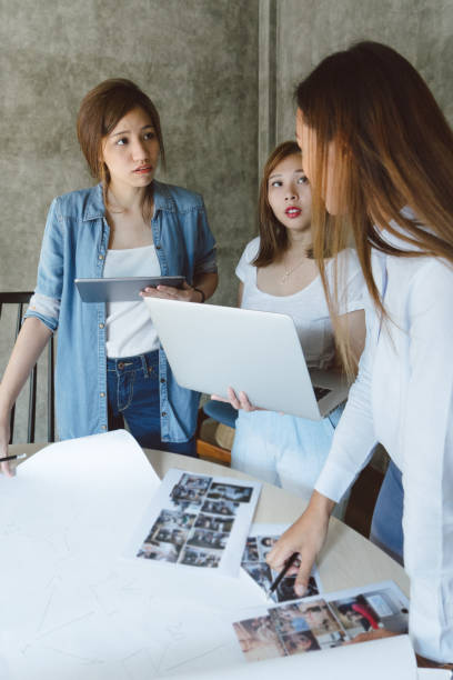 istock Female coworkers discussing a project in a new office space 694622758