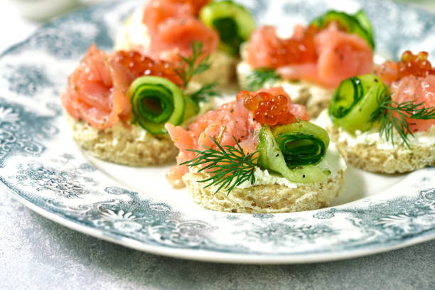 istock Canape with salmon,cucumber and red caviar 694624948