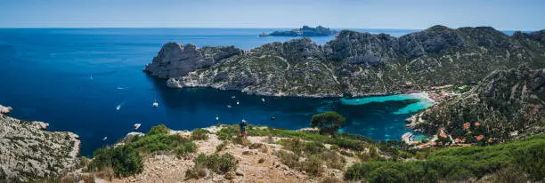 Scenic panoramic overview of Calanque de Sormiou harbor in Calanques National Park. Beautiful horizontal travel destination postcard, poster, banner.