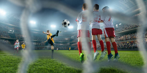 istock Soccer kids player makes a free kick 694657816