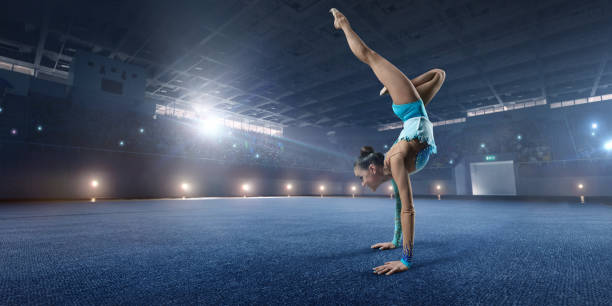 istock A gymnast girl makes performance on a large professional stage 694657962