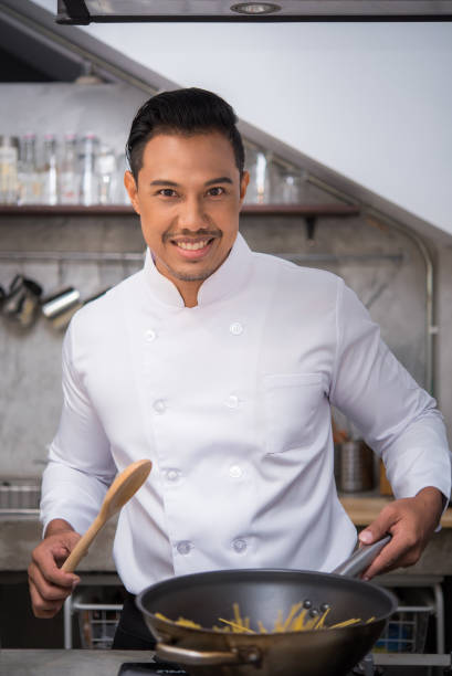 istock chef preparing food in the kitchen of a restaurant 694672616