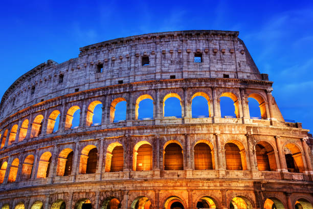 istock Colosseum in Rome, Italy. Amphitheatre illuminated at night 694676232