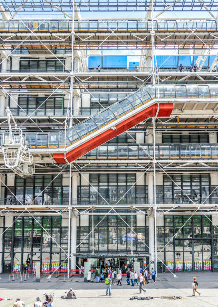 Pompidou Center in Paris Detail of the Pompidou Center in Paris. This unique building is a milestone of modern architecture and it houses the largest collection of modern art in Europe. There are visitors outside the building captured in this photo. pompidou center stock pictures, royalty-free photos & images