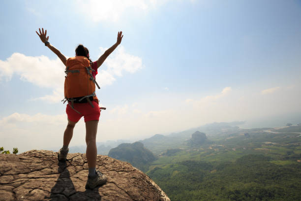 istock successful woman hiker hiking on mountain peak 694679628