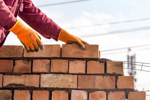 istock Worker builds a brick wall in the house 694685776