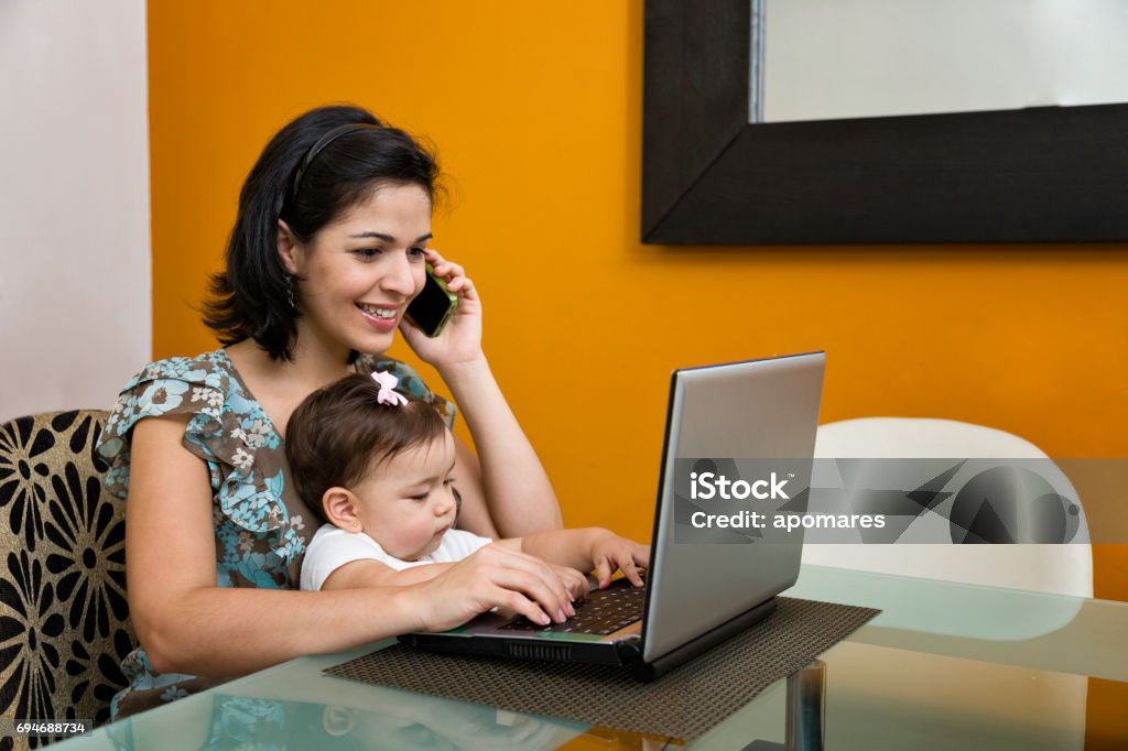 Multi Task Bebe Multi Tasking Mother With Child On Her Lap Stock Photo - Download Image ...