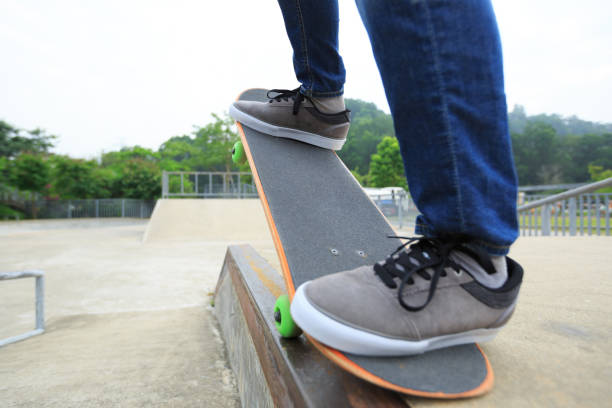 istock young skateboarder legs riding skateboard at skatepark 694695276
