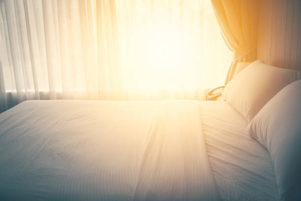 Unmade hotel bed with breakfast tray