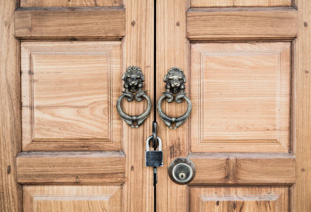 istock wooden door with handle and padlock 694706580