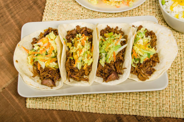 istock Pork tacos on a white serving plate 694715542