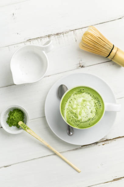 istock Green tea matcha latte vertical top view 694715716