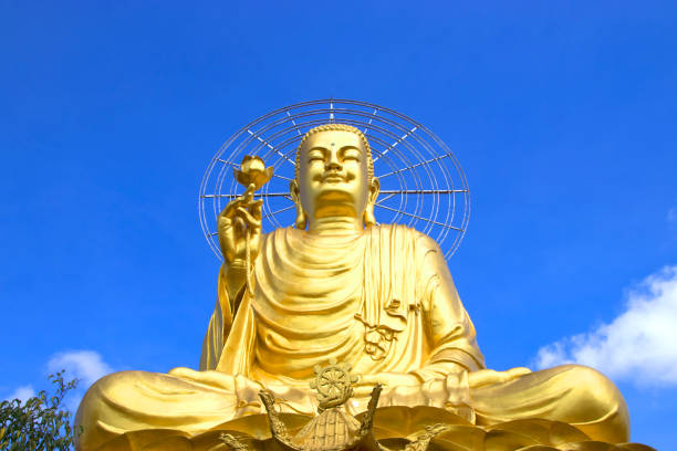 istock big golden buddha with blue sky and clouds. 694722692