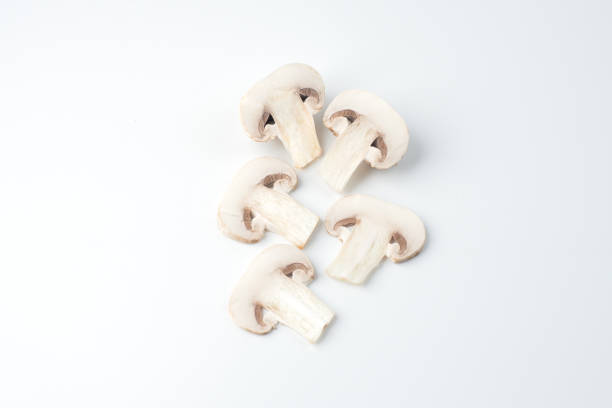 istock Isolated sliced white mushrooms, white background 694733036