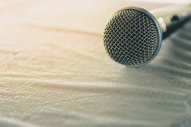 istock Closeup of Microphone on table in Conference Seminar room With the sunlight 694733242