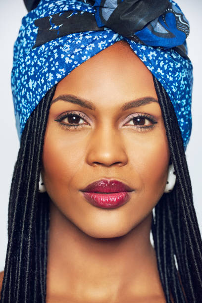 istock Young black woman with blue headscarf 694742744