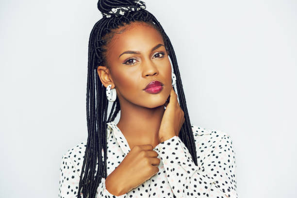 istock Black woman with traditional bunches touching neck 694742796