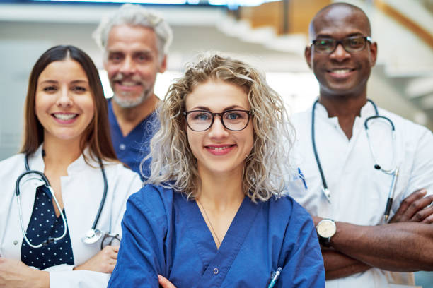 istock Cheerful medics looking at camera in clinic 694743258