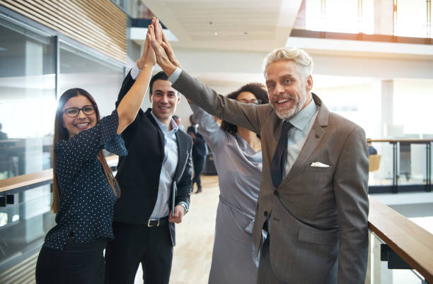 istock Positive business people giving high five in office 694746564