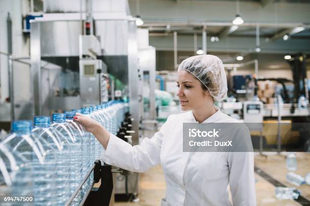 Young Woman Factory Worker Stock Photo - Download Image Now - Bottling Plant, Gallon, Water