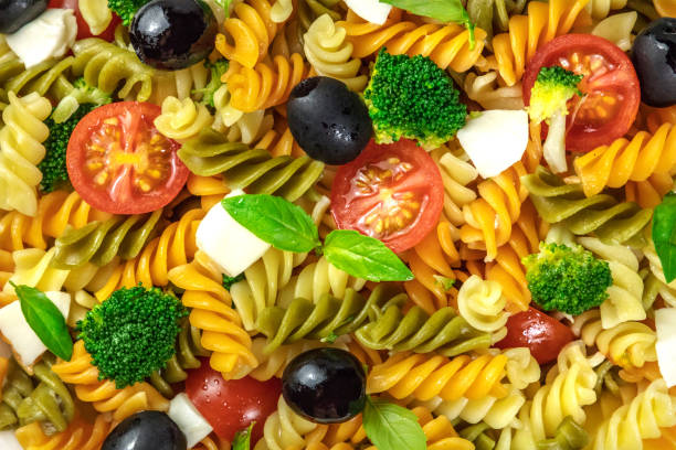 Closeup of pasta salad with cheese and vegetables