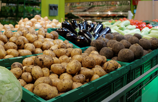 Vegetables in green plastic crates, supermarket food store