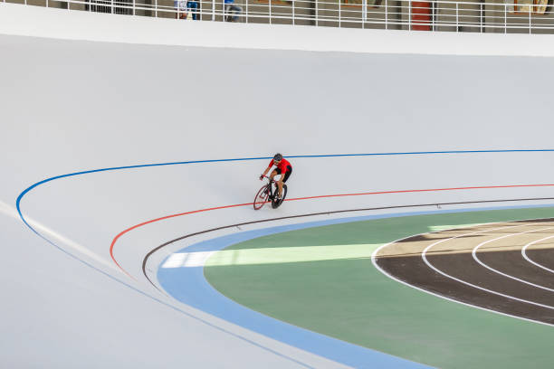 istock Young professional cyclist on a velodrome 694764156