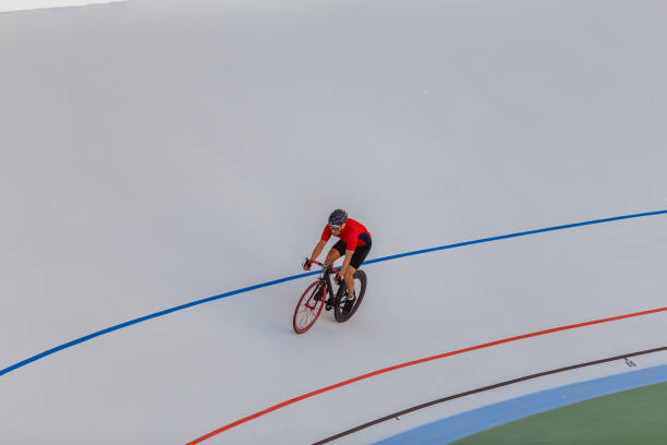 istock Young professional cyclist on a velodrome 694764334
