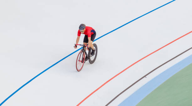 istock Racing cyclist on velodrome outdoor 694764392