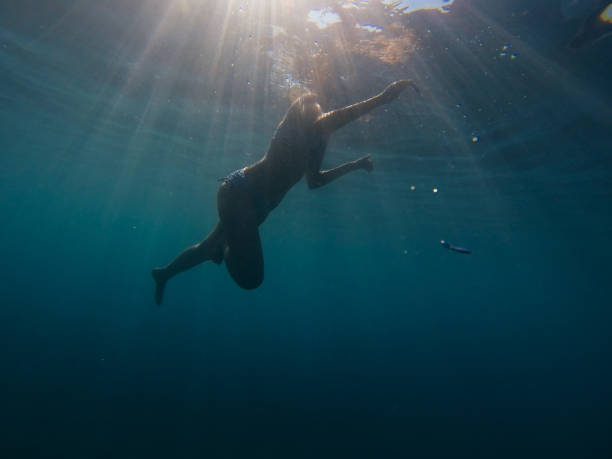 istock Woman swimming in sea 694764722