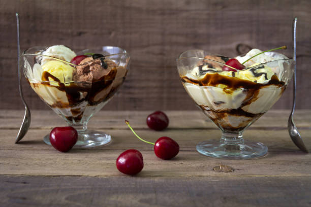 istock Mixed ice cream in a bowl with cherries on a wooden background 694767250