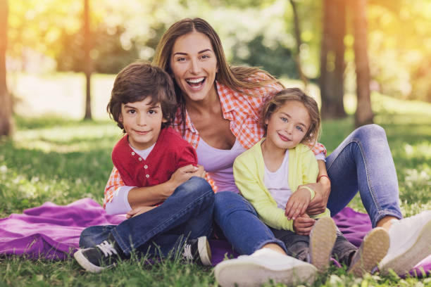 istock Mother with two children on a picnic 694767620