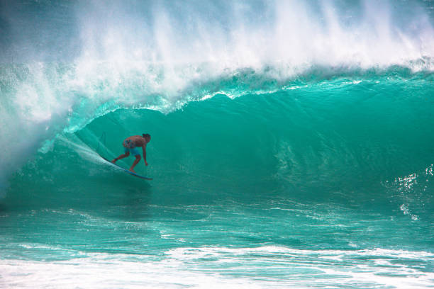 istock Surfer riding big green wave in Bali 694771994