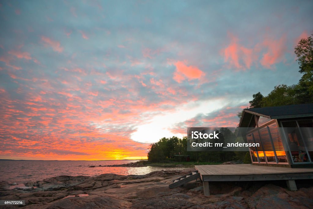 Beach summer house terrace sunset Summer beach cottage on Åland Islands in Finland at sunset Cottage Stock Photo