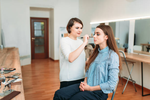 istock Female make up artist work with woman face 694777718