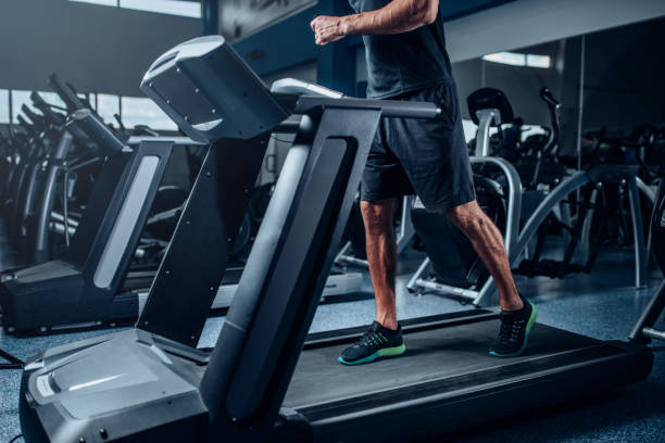 istock Male person workout on running exercise machine 694781670