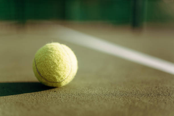 istock Tennis ball on ground coverage closeup 694784972