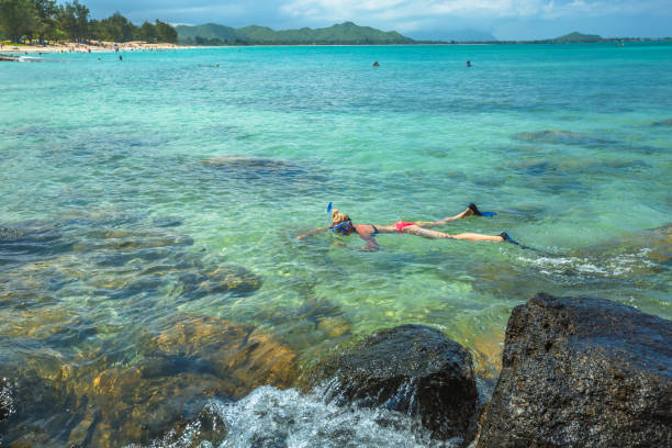 istock Woman snorkeling in Hawaii 694792194