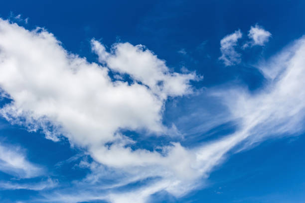 istock White fluffy clouds in the blue sky background 694795658