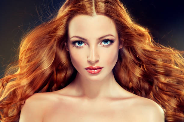istock Model with long, dense and curly hairstyle. Red hair. 694805280