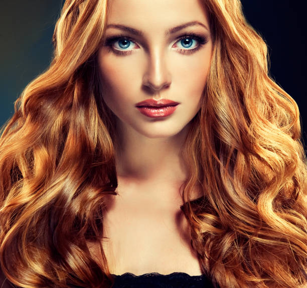 istock Model with long, dense and curly hairstyle. Red hair. 694805284