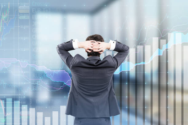 istock Businessman looking at graphs in office 694809026