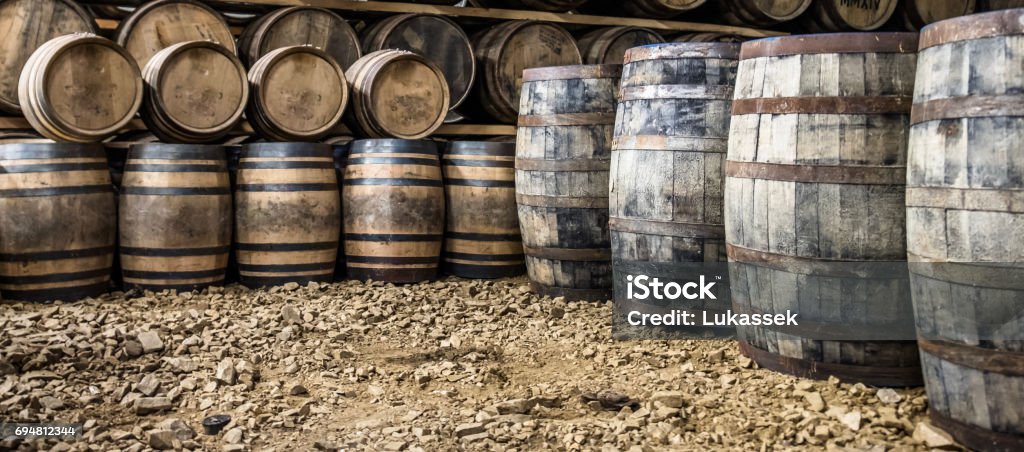 Whisky barrels in the store house Whisky barrels in warehouse of distillery in Scotland Bourbon Whiskey Stock Photo