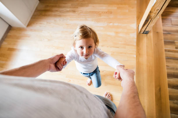 istock Unrecognizable father with his cute little daughter at home. 694824920
