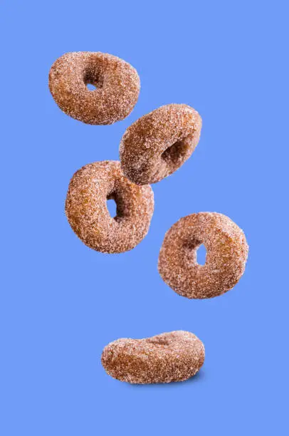 Round sugar donuts on isolated background. Selective focus.