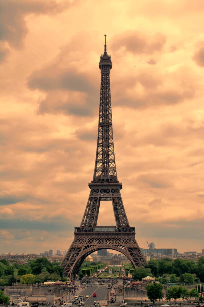 istock Eiffel Tower in Paris at sunset with cumulus clouds. Tour Eiffel at sunset. 694825712